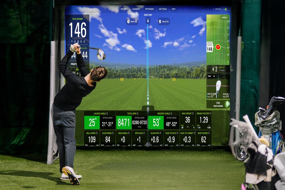 Launch monitor shot data displayed on a golf simulator impact screen